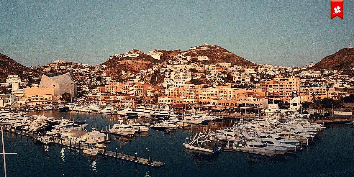 Cabo San Lucas marina and hillside town at dusk – airport transfer to Breathless