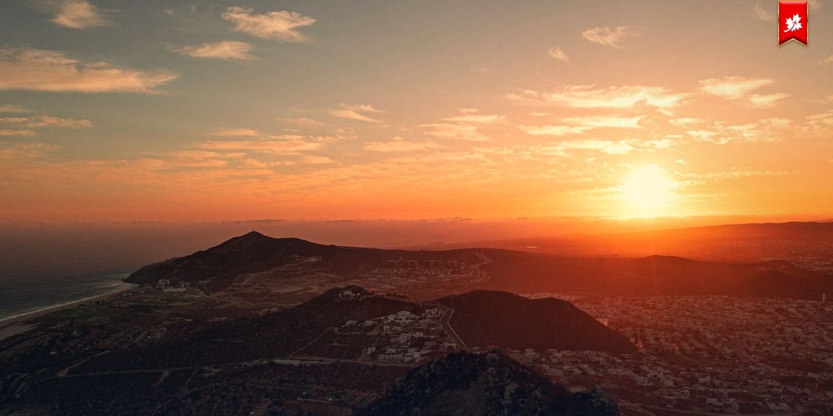Orange sun low over the coastal hills of Los Cabos – airport transfer to Esperanza