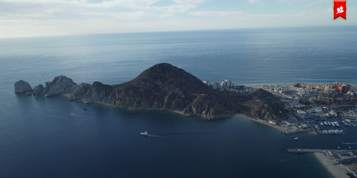 Aerial view of the Cabo San Lucas headland over dark blue water – airport transfer to Four Seasons Costa Palmas