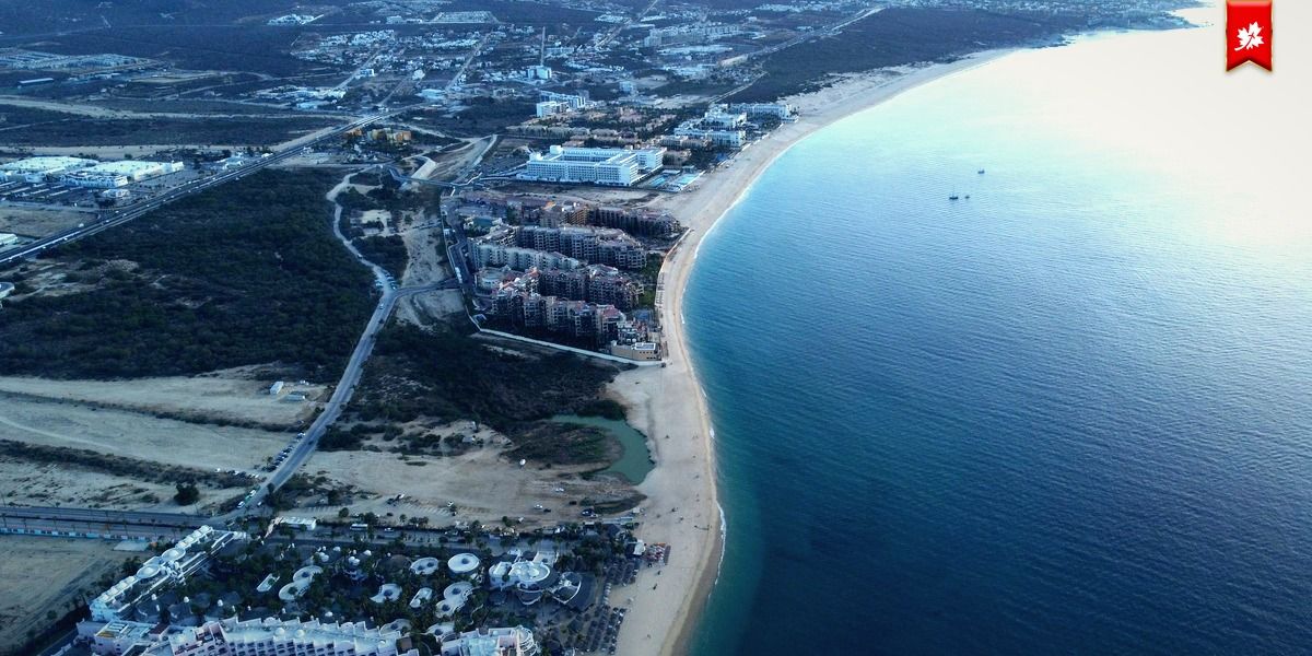 Aerial view of a long sandy beach along the Cabo coast – airport transfer to Hilton