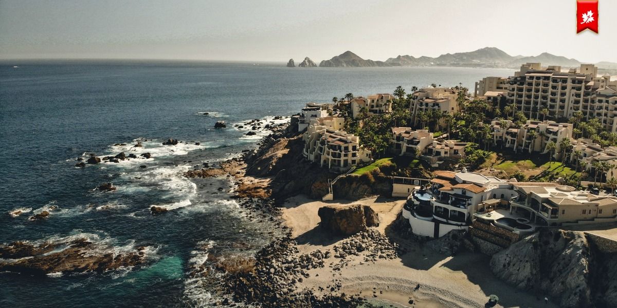 Cliffside villas and rocky shoreline near Land's End – airport transfer to Krystal Grand