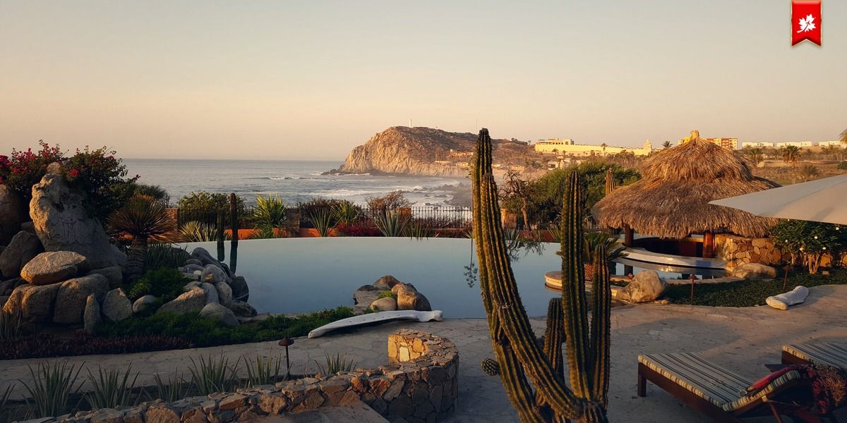 Infinity pool with cactus and a thatched palapa facing the sea – airport transfer to Nobu