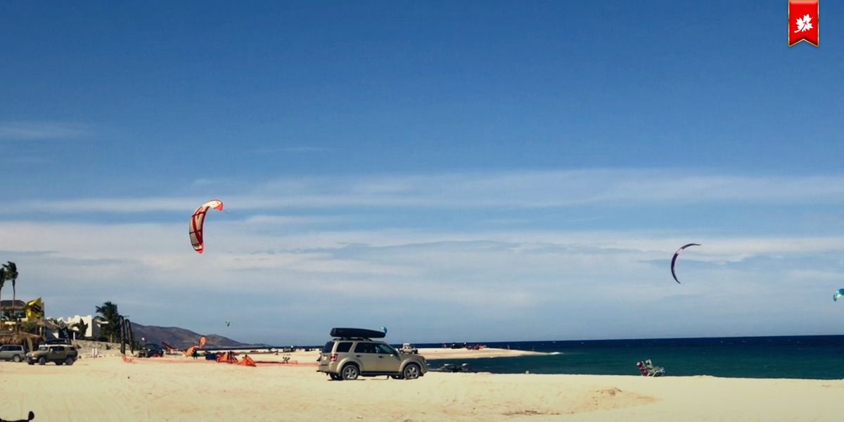 Kitesurfing kites over a wide sandy beach in Los Barriles – airport transfer to Palmas de Cortez