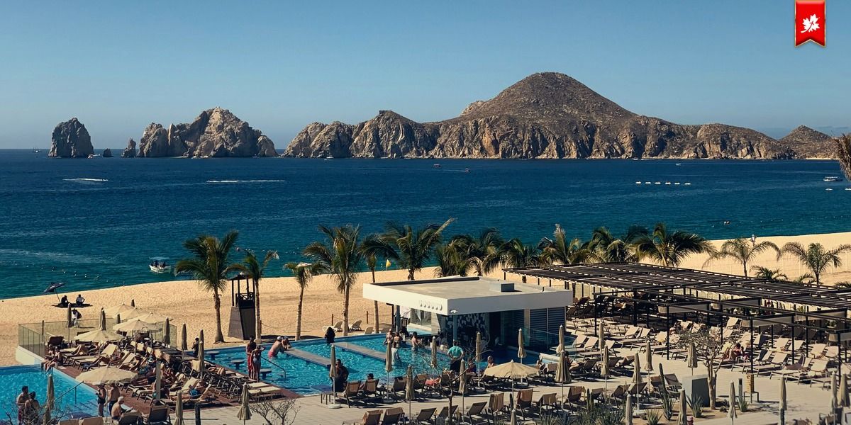 Land's End rocks, pool and beach loungers from a resort terrace – airport transfer to Riu Baja California