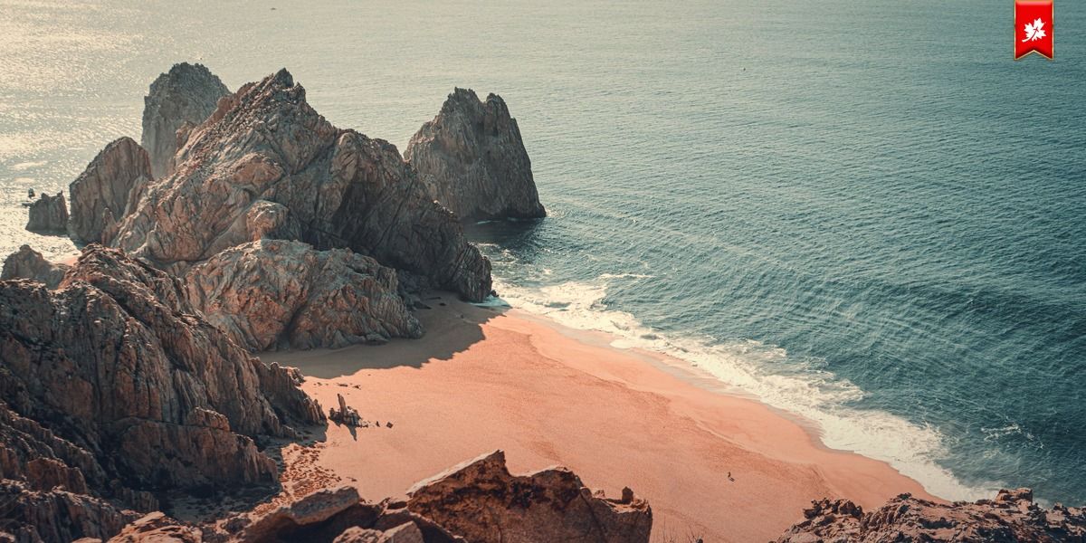 Rocky Cabo cove with a pink-sand beach, seen from above – airport transfer to Waldorf Astoria